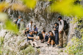 Participants at the Mrtvica, a tributary of the Morača River, that is flanked by towering rock walls that rise steeply on either side.
